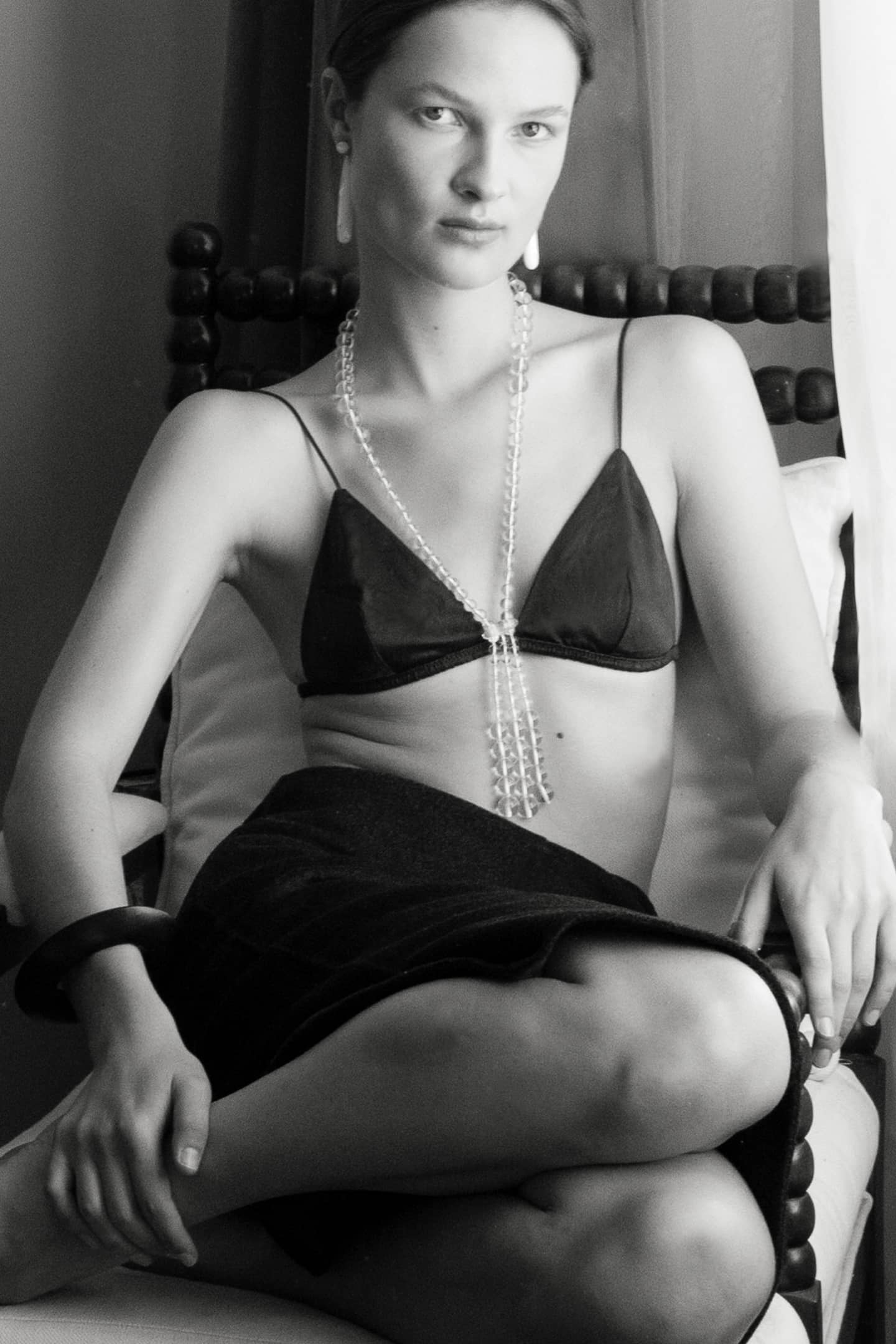 Model wearing the Pipa crystal quartz necklace, a handcrafted gemstone piece made slowly in our atelier.
