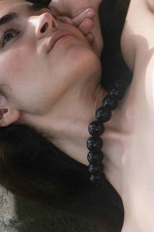 Side view of Benijo necklace showcasing the combination of natural materials and artisanal finish