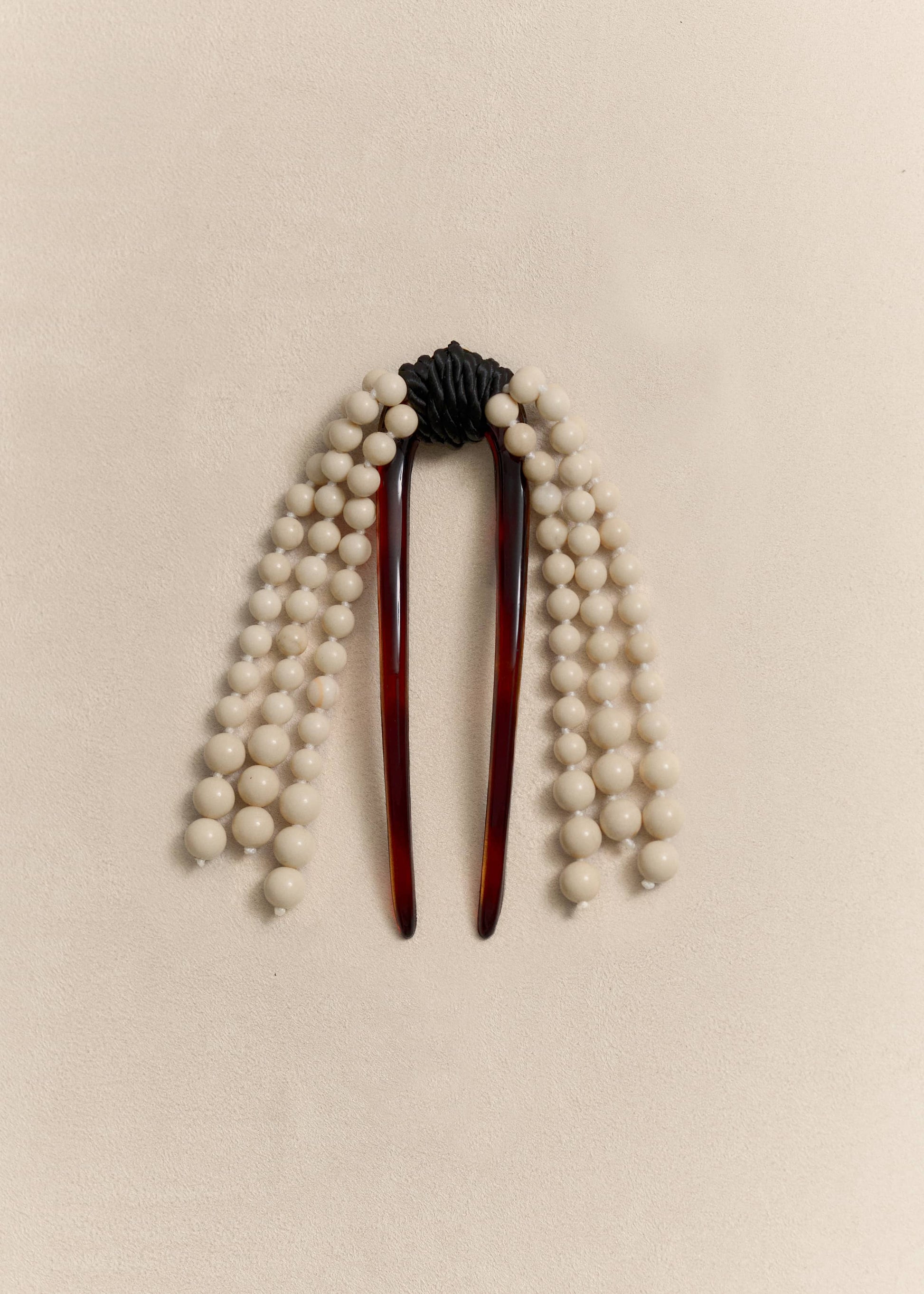 A handcrafted hair comb combining sculptural design with traditional craftsmanship and carefully sourced natural materials.