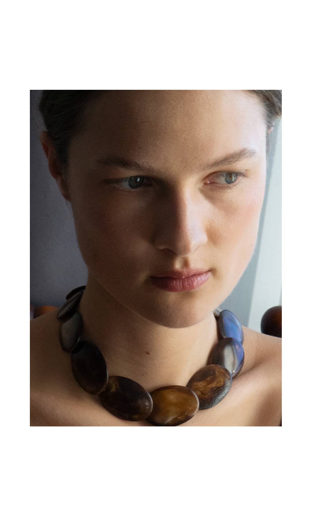 Close-up of the Gaviota necklace, showcasing individually knotted upcycled bone beads strung on silk thread.