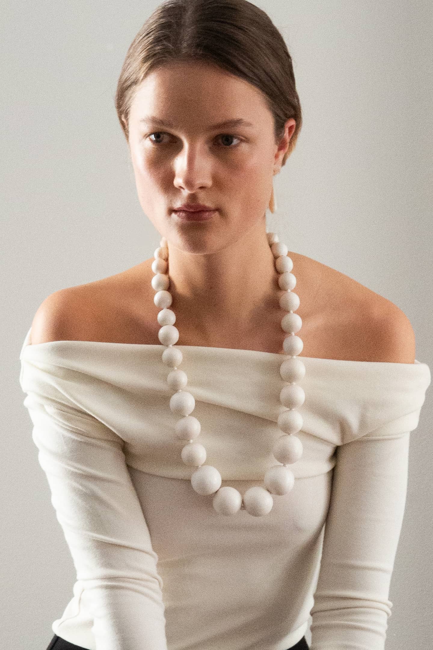 Full view of the Positano necklace made with yakal wood beads, a handcrafted modernist jewelry piece.