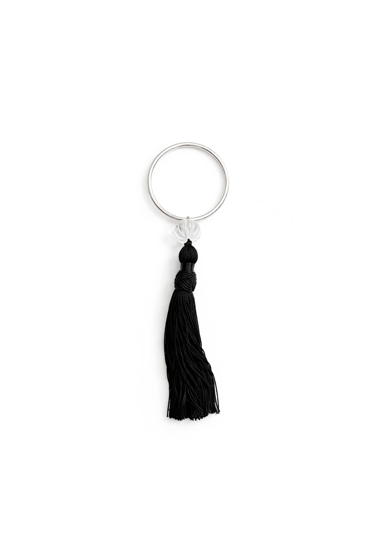 Lacanau bracelet showing carved crystal quartz bead and handmade silk tassel.