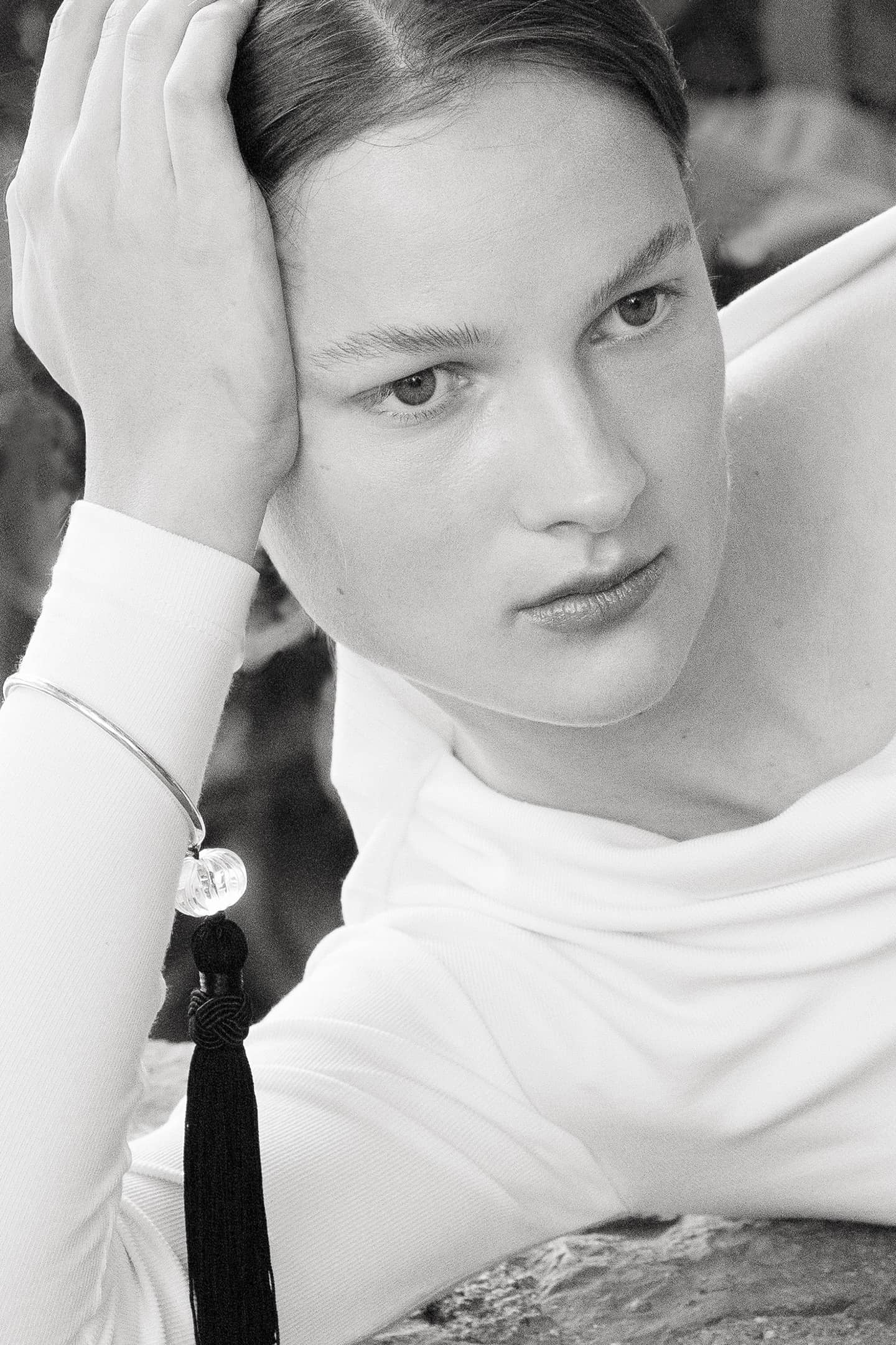 Model wearing the Lacanau bracelet crafted with sterling silver, crystal quartz bead and silk tassel.