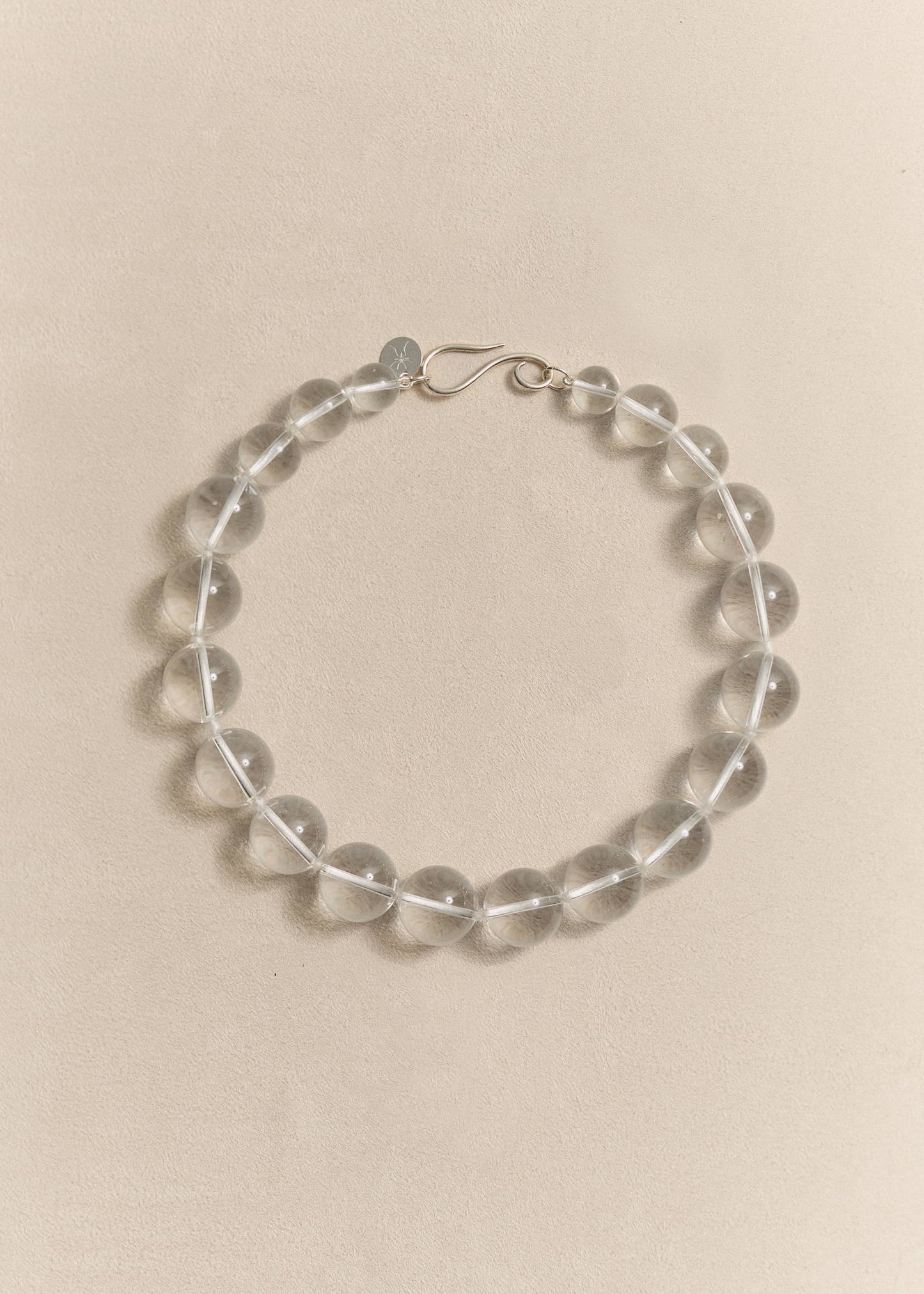 A handcrafted sterling silver necklace featuring natural rock crystal. Sculptural simplicity shaped by traditional craftsmanship.