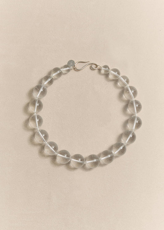 A handcrafted sterling silver necklace featuring natural rock crystal. Sculptural simplicity shaped by traditional craftsmanship.