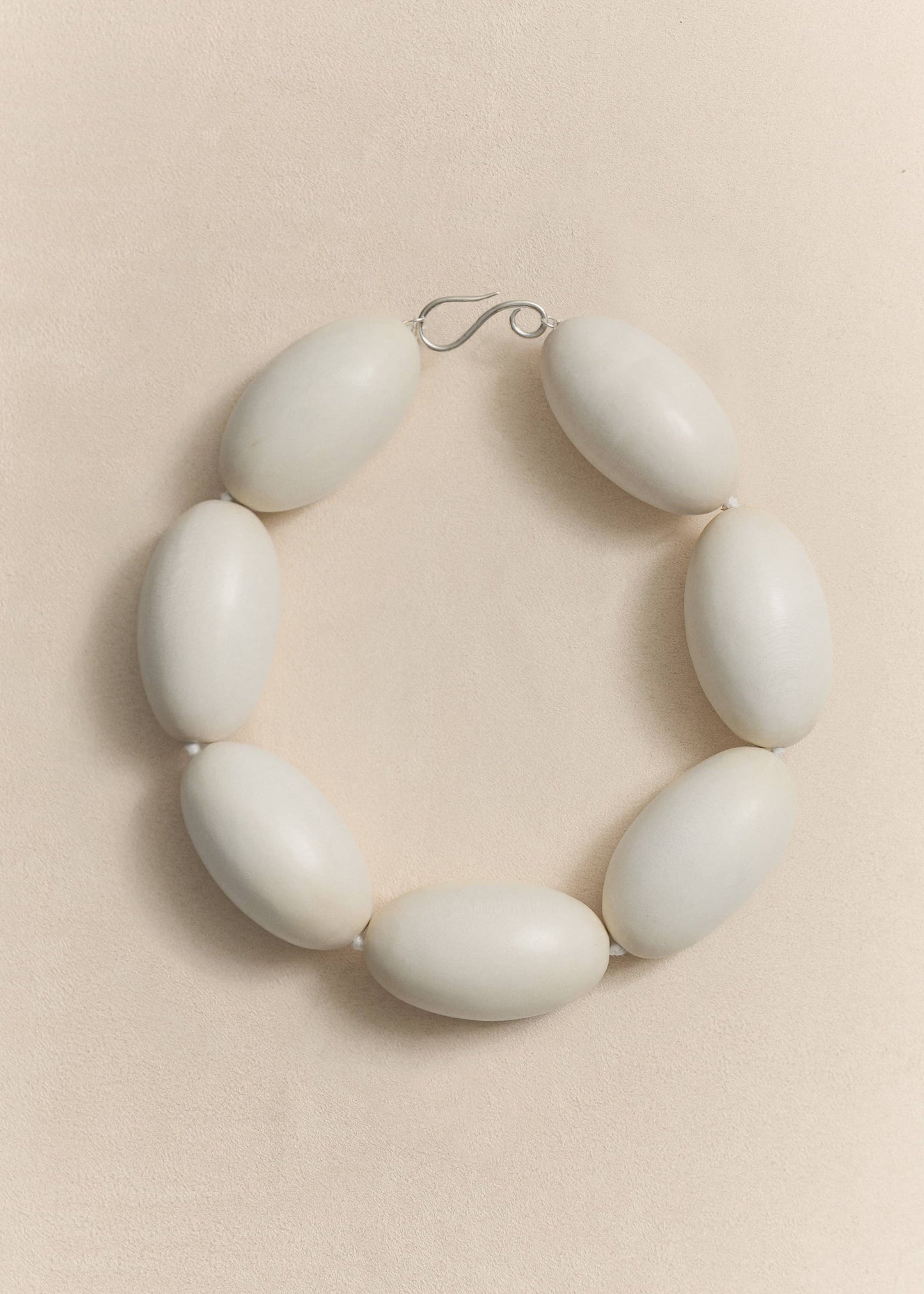 A handcrafted necklace made from natural yakal wood and sterling silver. A quietly sculptural piece created in small batches using traditional techniques.