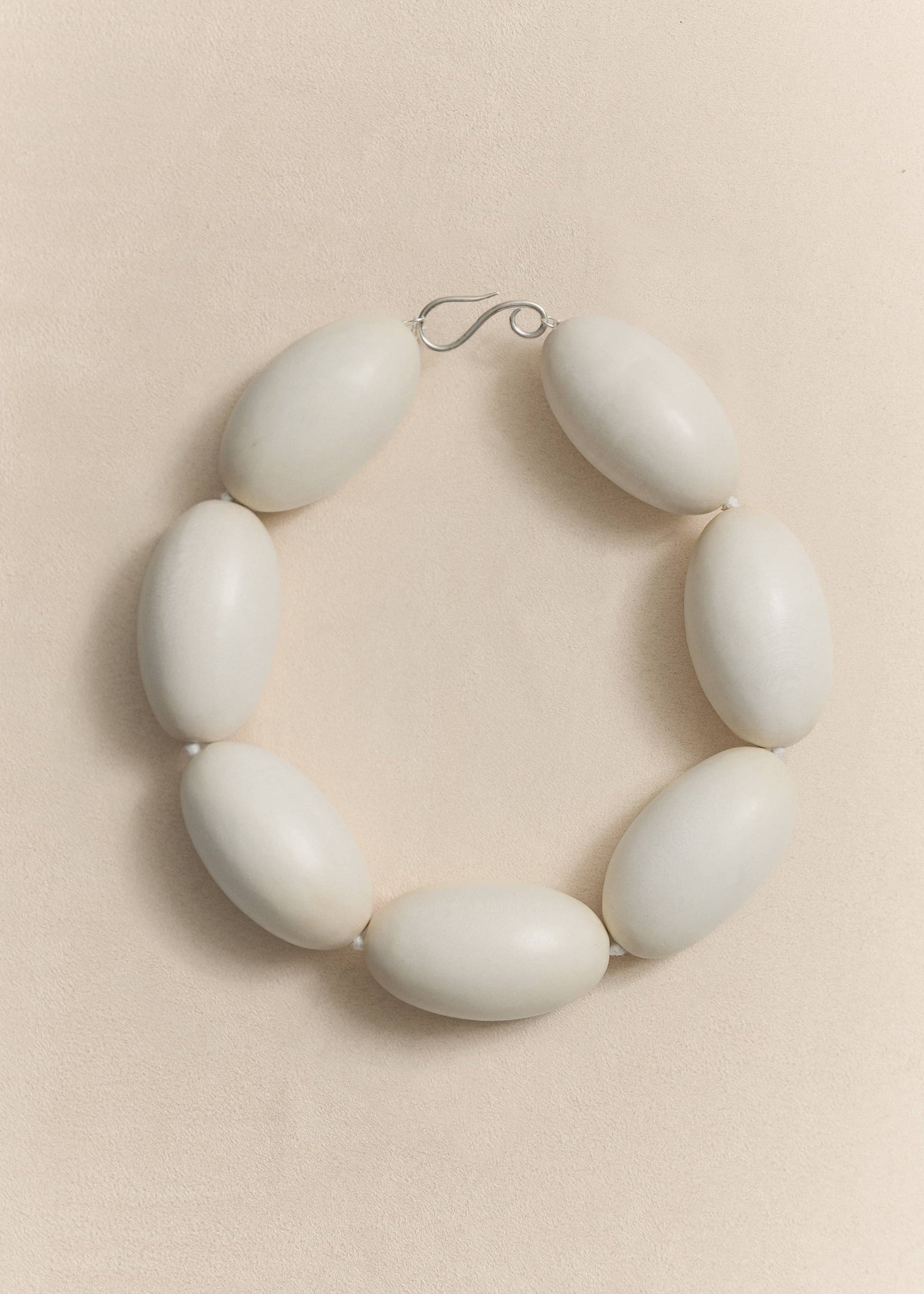 A handcrafted necklace made from natural yakal wood and sterling silver. A quietly sculptural piece created in small batches using traditional techniques.