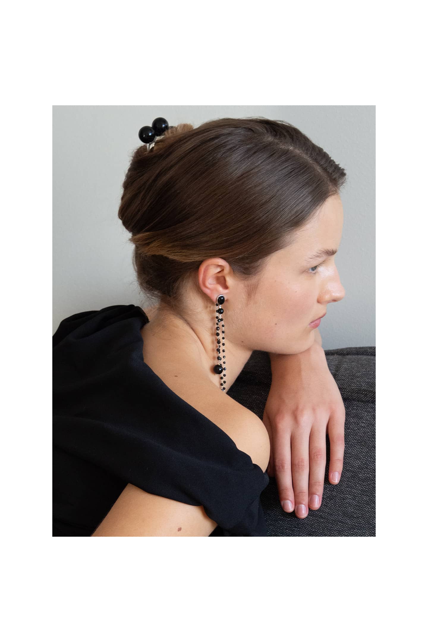 Detail of the Nusa hair comb showing three polished onyx spheres on a silver-plated brass base.