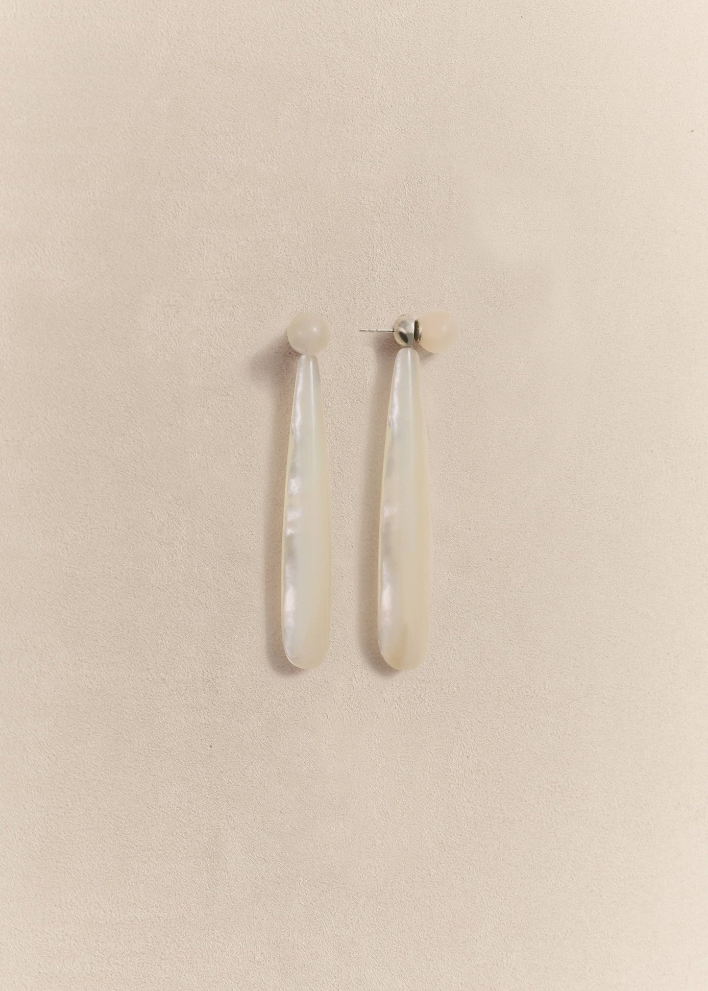 Sculptural sterling silver earrings with luminous mother of pearl. Handmade in small batches using traditional techniques.