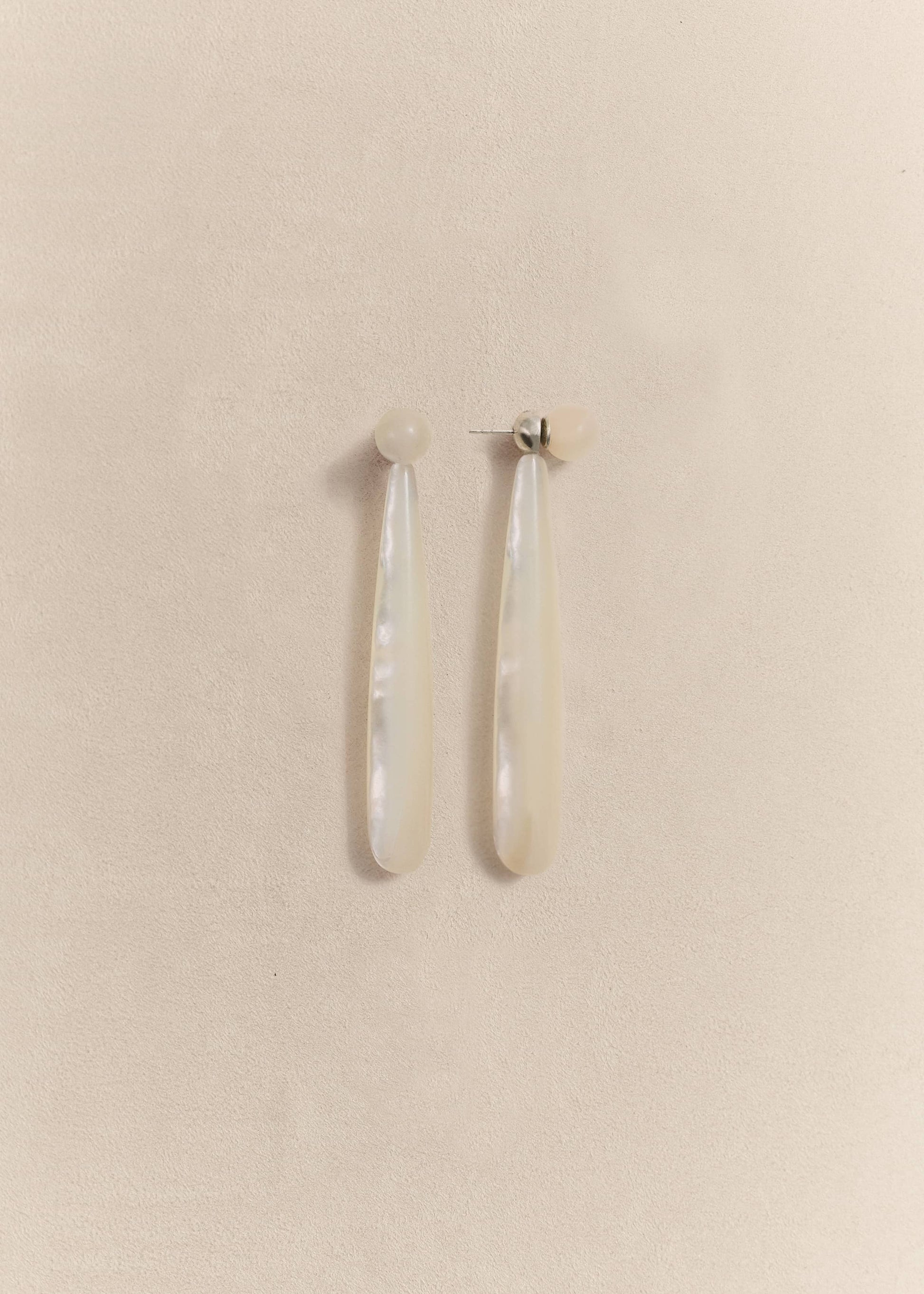 Sculptural sterling silver earrings with luminous mother of pearl. Handmade in small batches using traditional techniques.