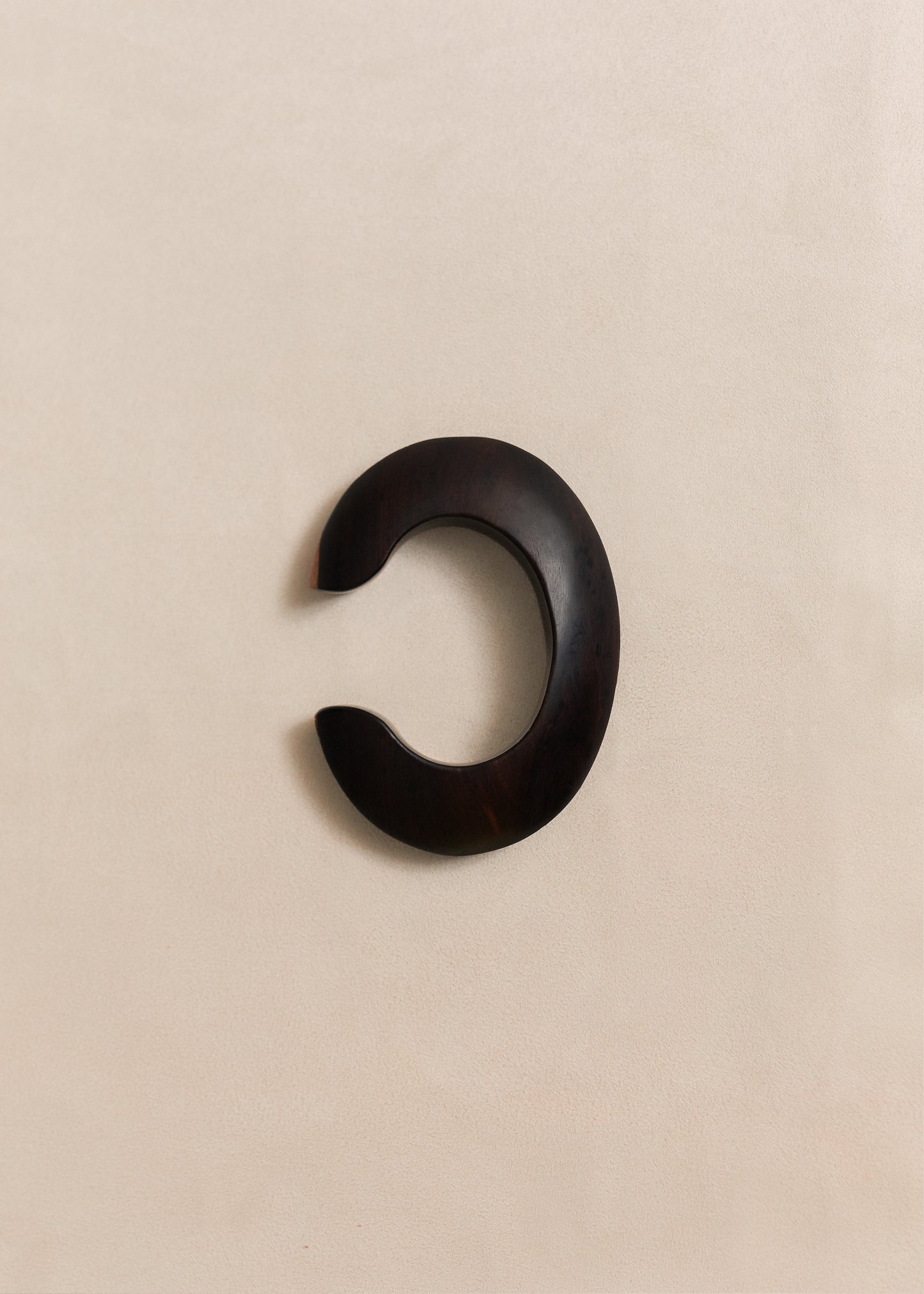 A handcrafted sterling silver bangle with sculptural lines and a quiet presence. Made in small batches using traditional silversmithing techniques.