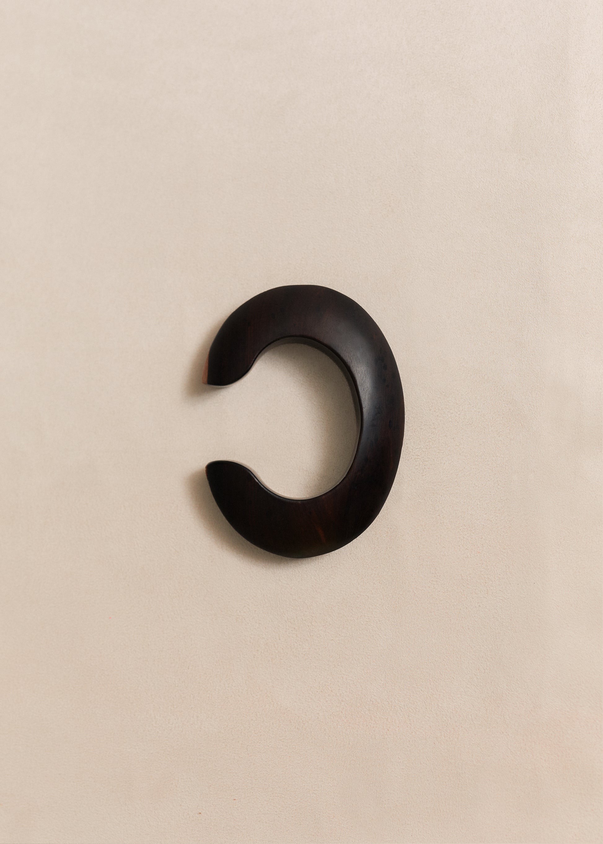 A handcrafted sterling silver bangle with sculptural lines and a quiet presence. Made in small batches using traditional silversmithing techniques.