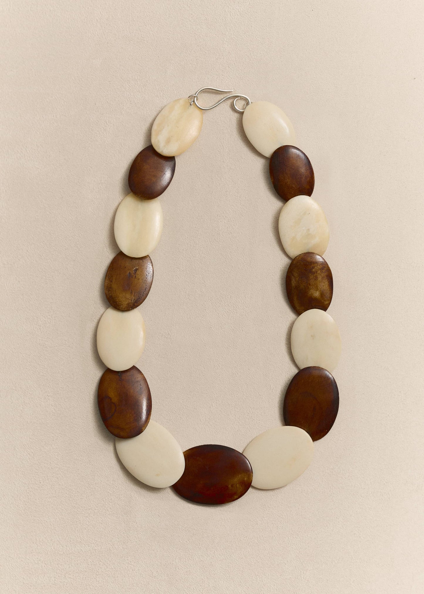 Handcrafted from responsibly sourced natural bone and sterling silver. A timeless necklace balancing sculptural form with everyday wearability.