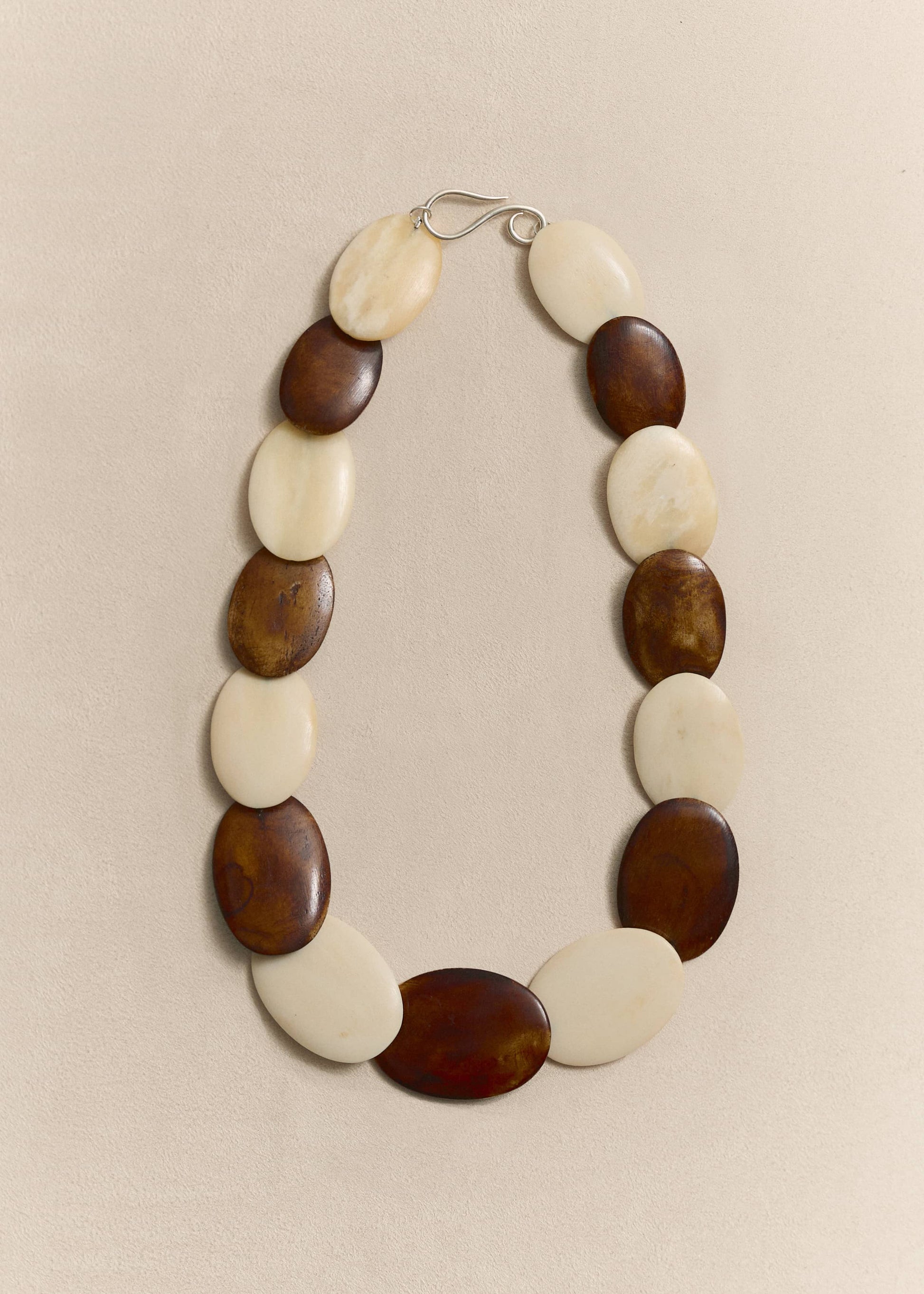 Handcrafted from responsibly sourced natural bone and sterling silver. A timeless necklace balancing sculptural form with everyday wearability.