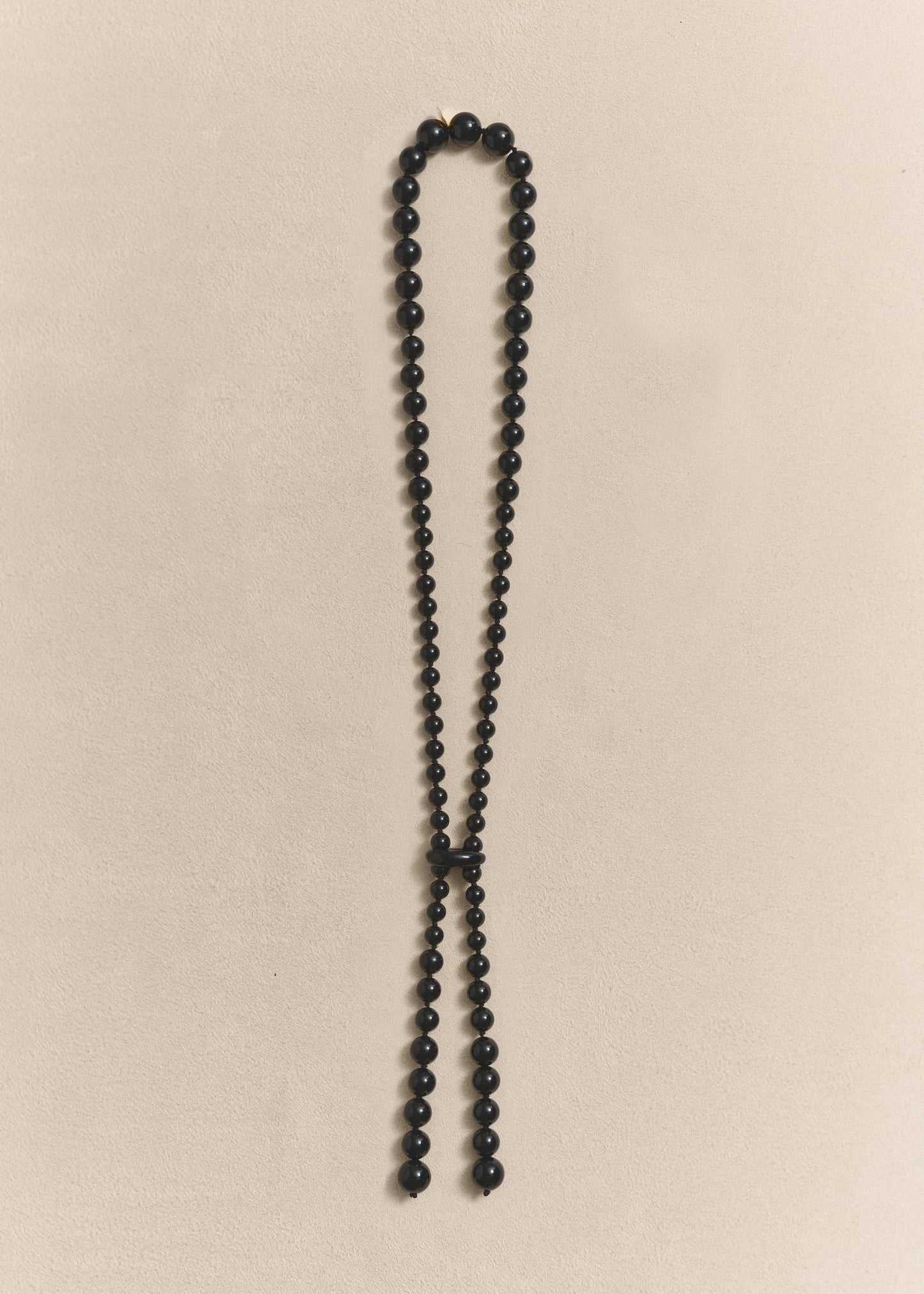 handcrafted necklace featuring sculptural onyx beads, silk thread and sterling silver. Knotted by hand using traditional techniques.