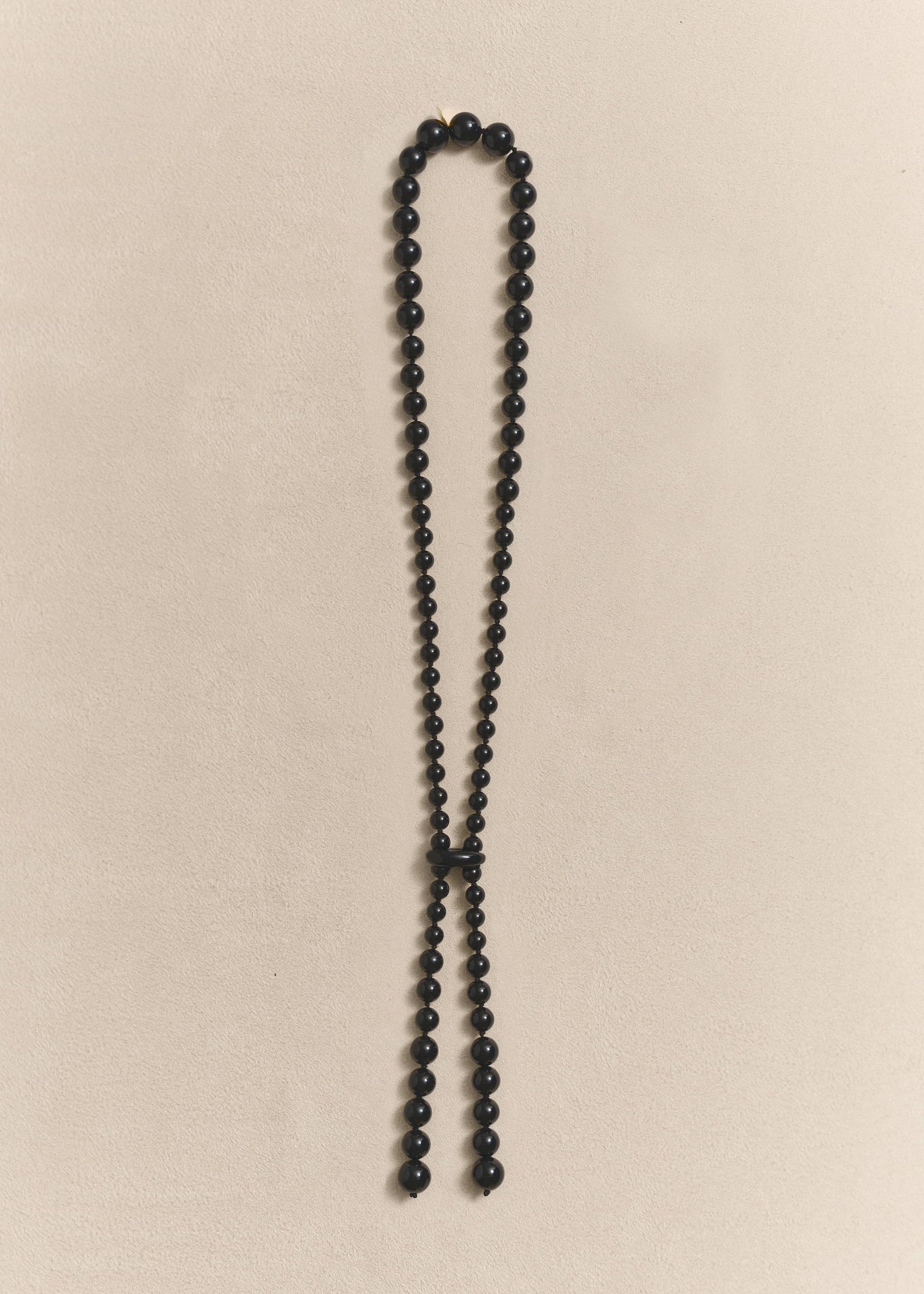 handcrafted necklace featuring sculptural onyx beads, silk thread and sterling silver. Knotted by hand using traditional techniques.