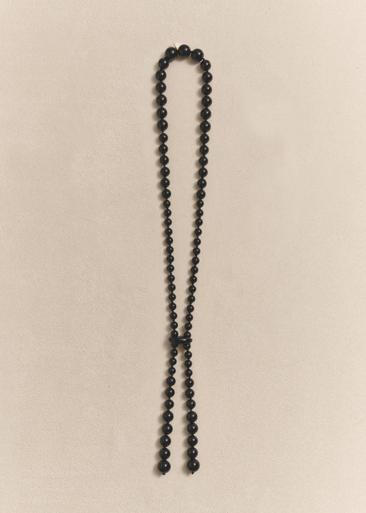handcrafted necklace featuring sculptural onyx beads, silk thread and sterling silver. Knotted by hand using traditional techniques.