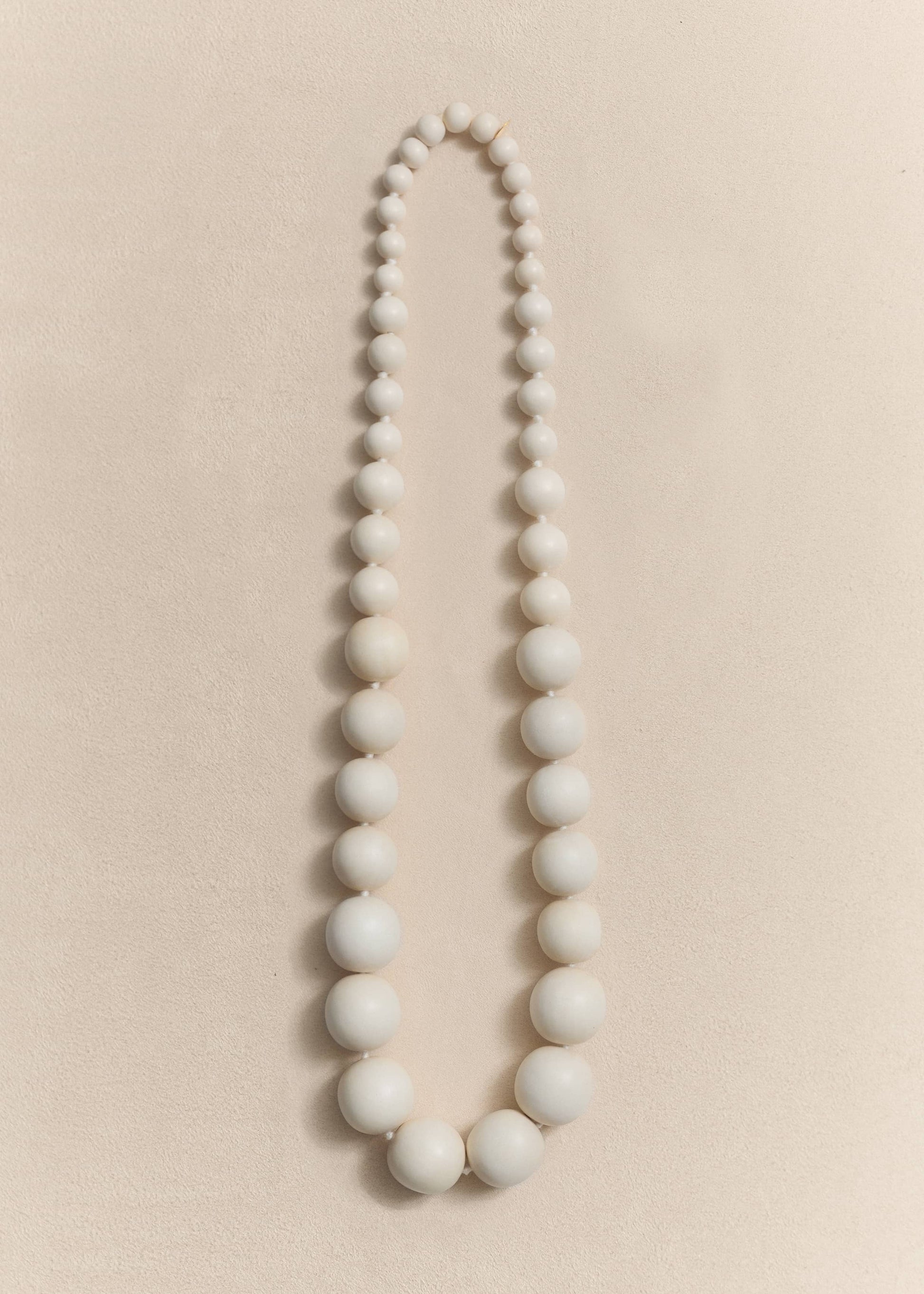 A handcrafted necklace made from natural yakal wood and sterling silver. Sculptural proportions shaped through slow craftsmanship.