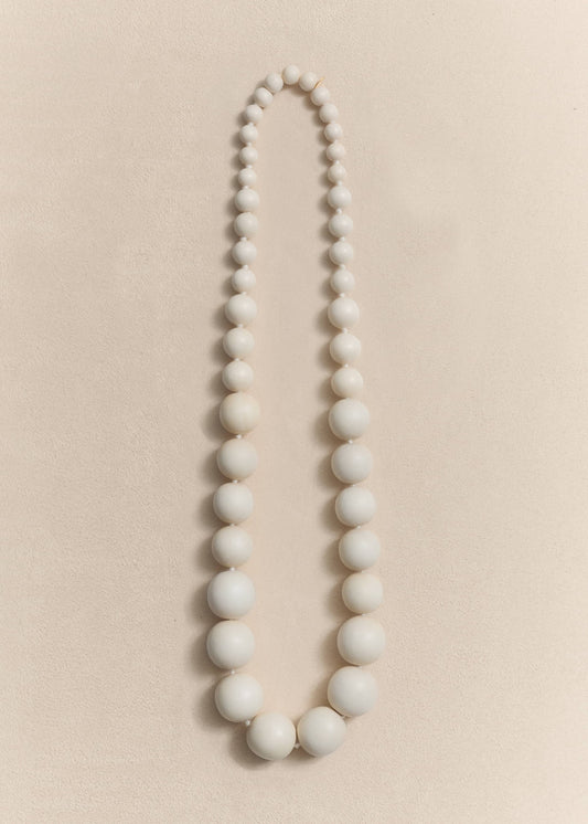A handcrafted necklace made from natural yakal wood and sterling silver. Sculptural proportions shaped through slow craftsmanship.