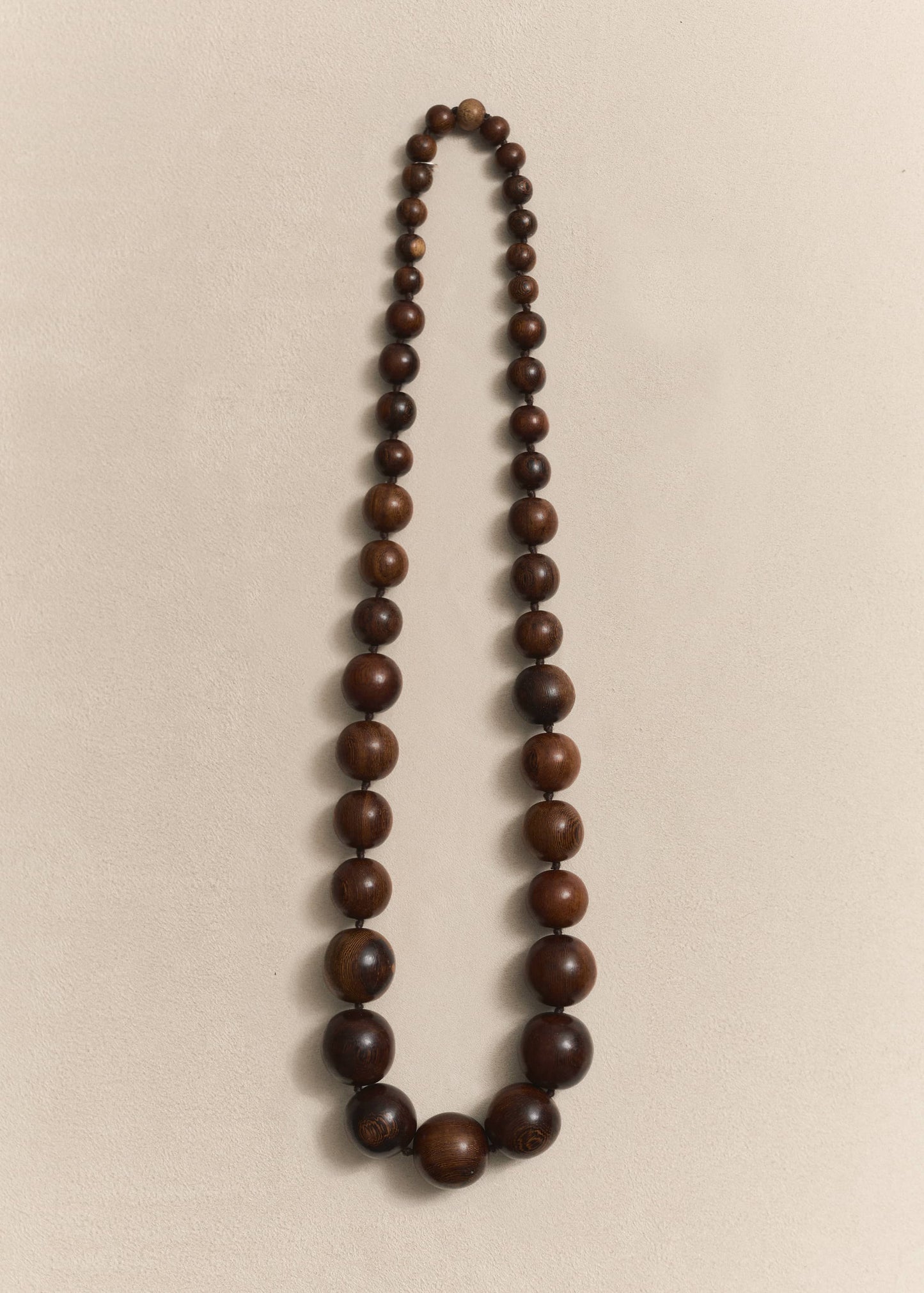 Handcrafted with natural oak, silk thread and sterling silver. A sculptural necklace defined by timeless form and traditional craftsmanship.