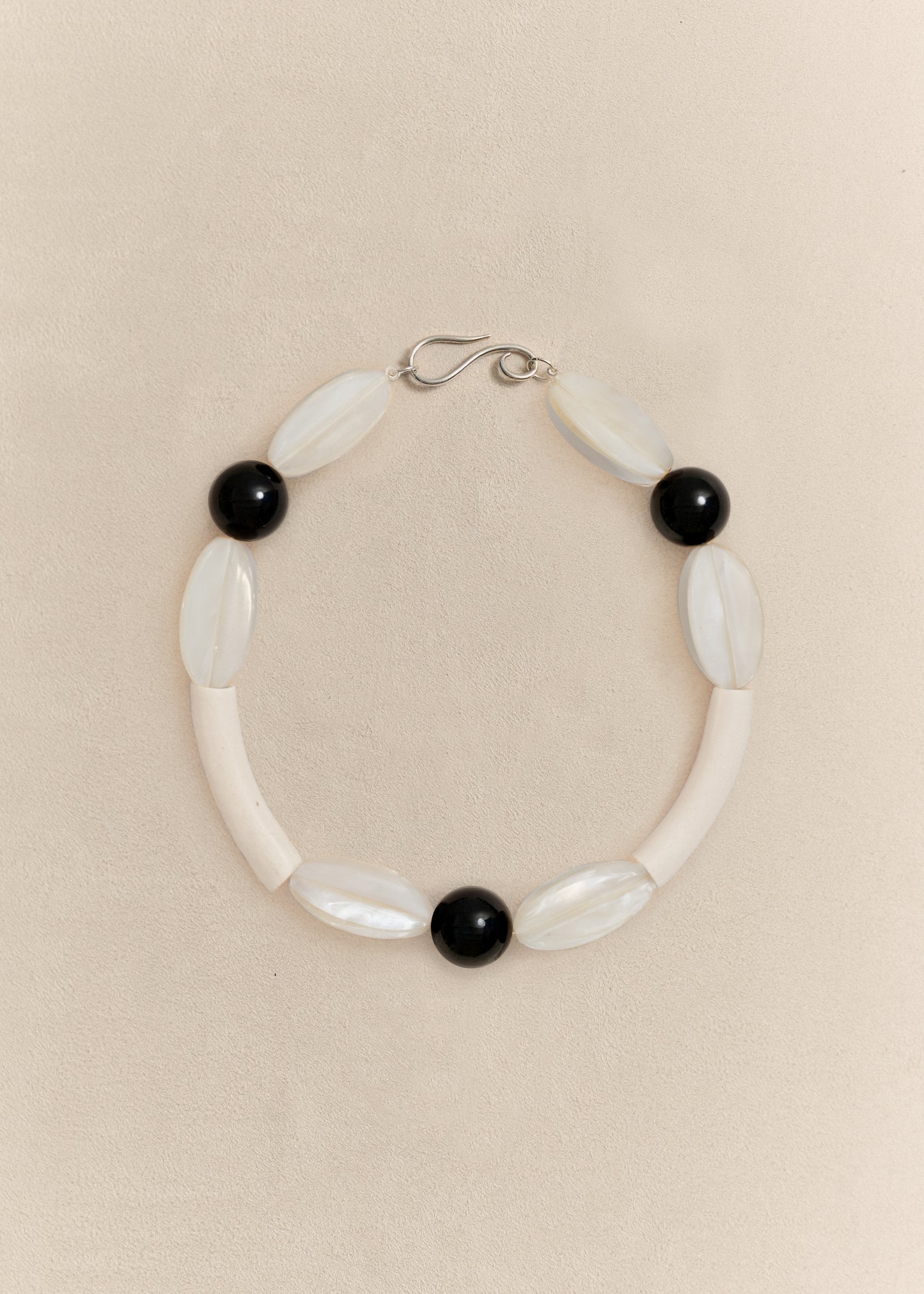 A handcrafted necklace combining sterling silver with carefully selected natural materials. Sculptural, timeless and made in small batches.