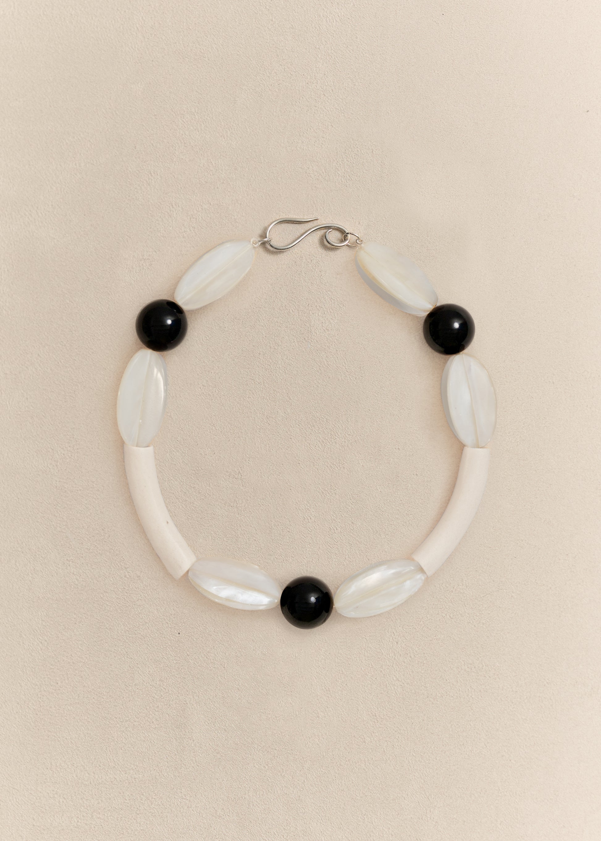 A handcrafted necklace combining sterling silver with carefully selected natural materials. Sculptural, timeless and made in small batches.