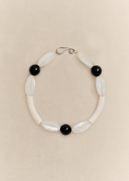 A handcrafted necklace combining sterling silver with carefully selected natural materials. Sculptural, timeless and made in small batches.