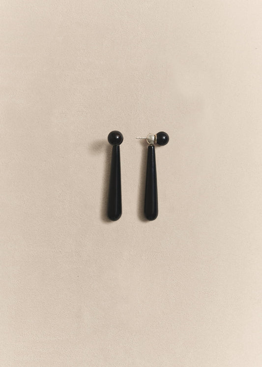 Handcrafted sterling silver drop earrings finished with polished onyx beads. Quiet, timeless and designed to last.