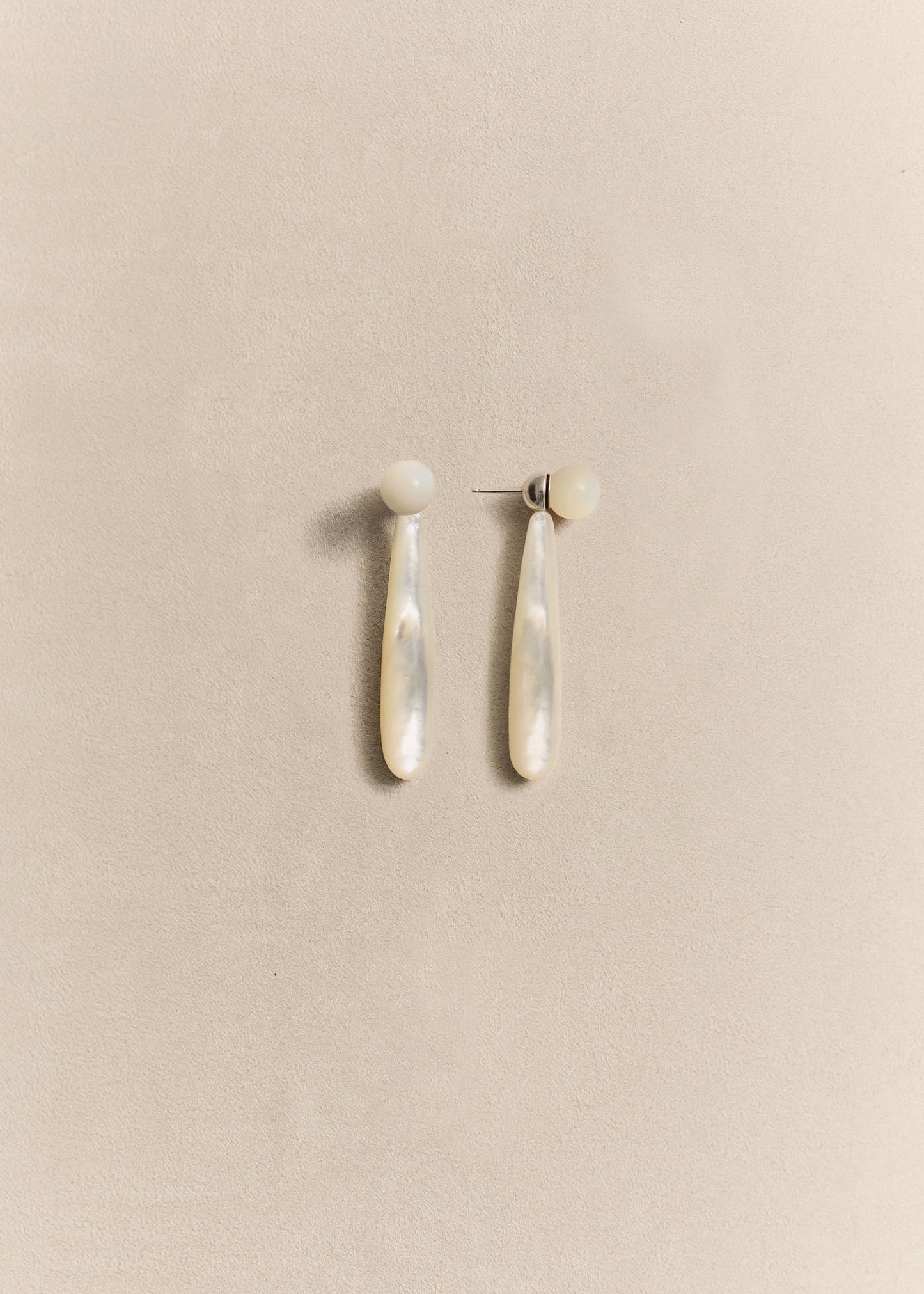 Handcrafted sterling silver drop earrings finished with luminous mother of pearl. Elegant, timeless and made in small batches.