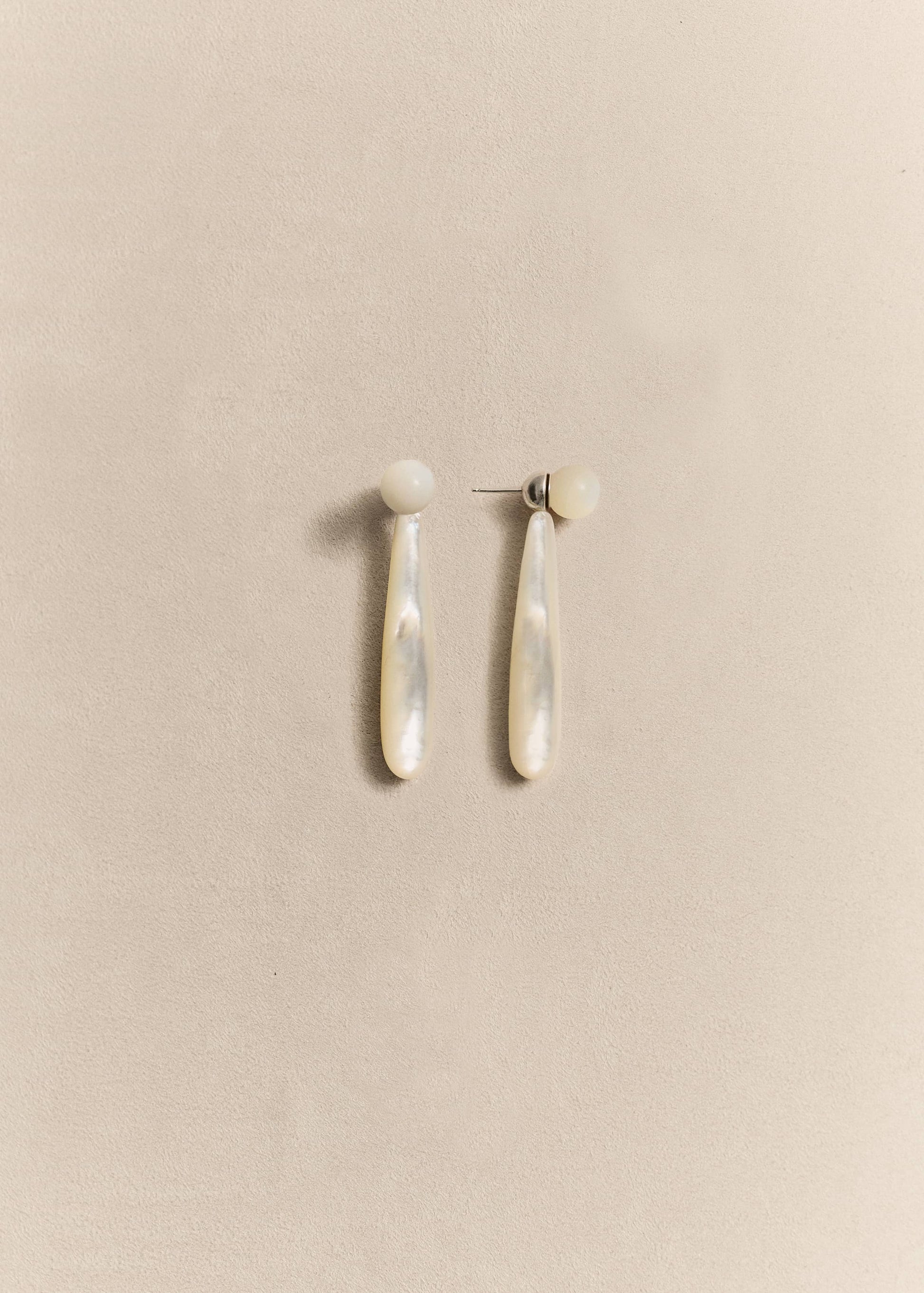 Handcrafted sterling silver drop earrings finished with luminous mother of pearl. Elegant, timeless and made in small batches.