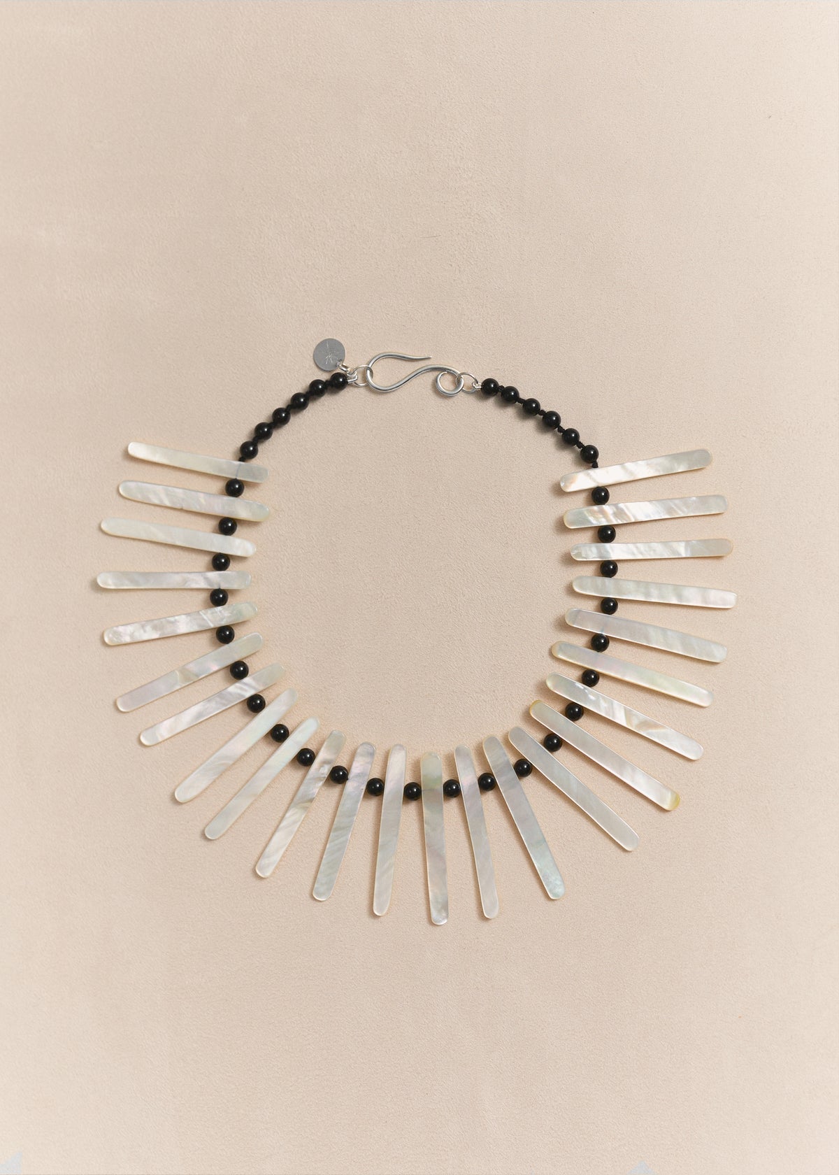 Handmade statement necklace featuring pearl, black onyx and sculptural elements, created in small batches by Mosquito.