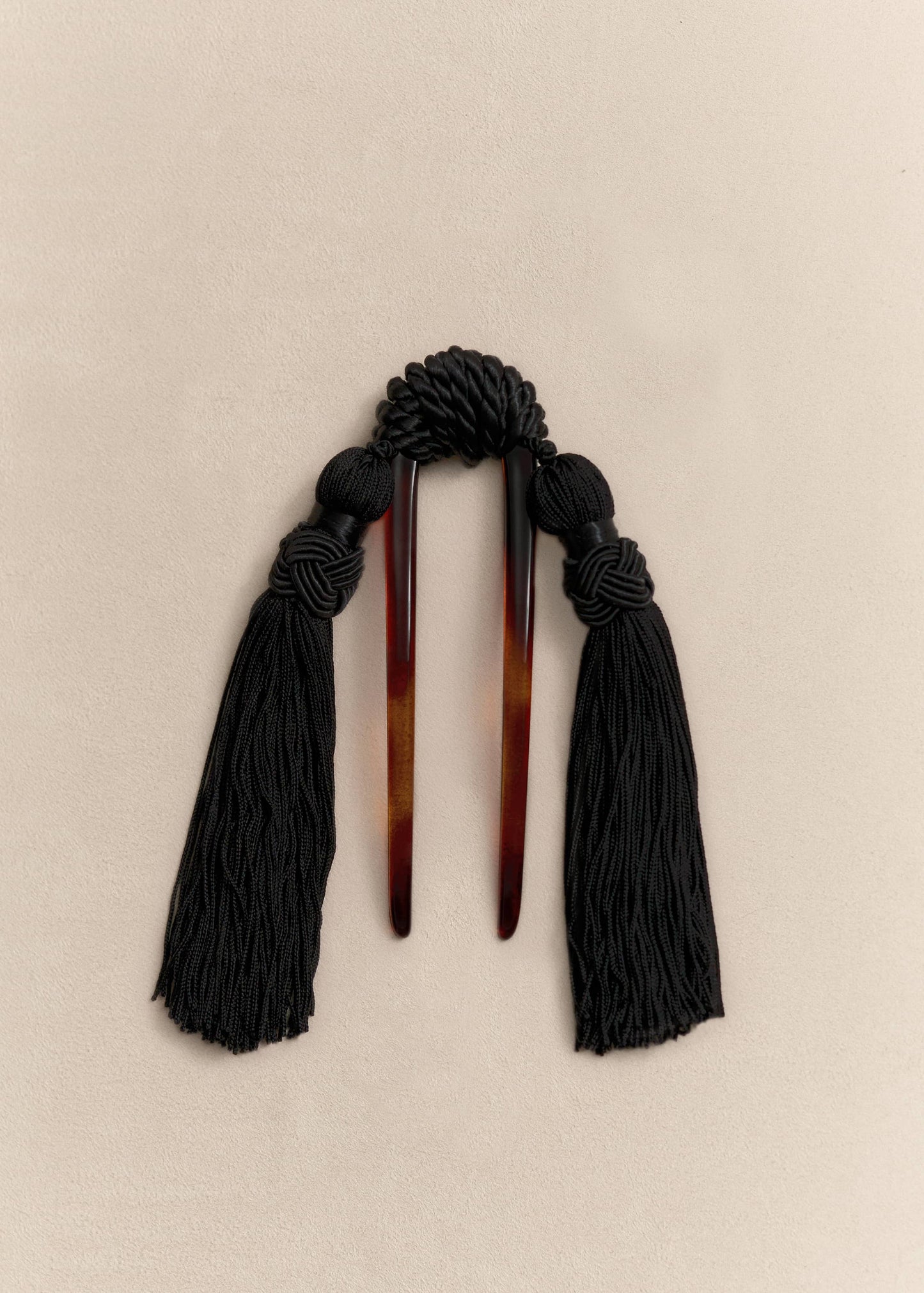 A handcrafted hair comb balancing sculptural form and movement through carefully selected natural materials.