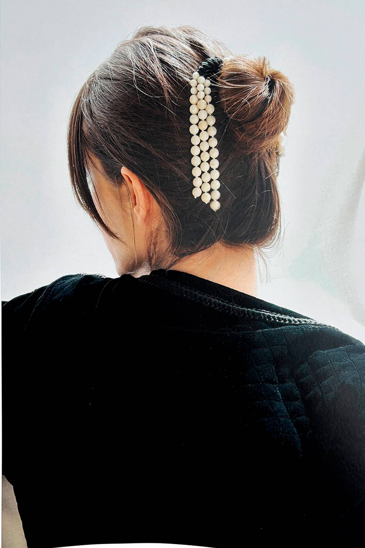 Close-up of CANDE hair comb showing jade tassels and silk thread detail sustainable luxury accessory