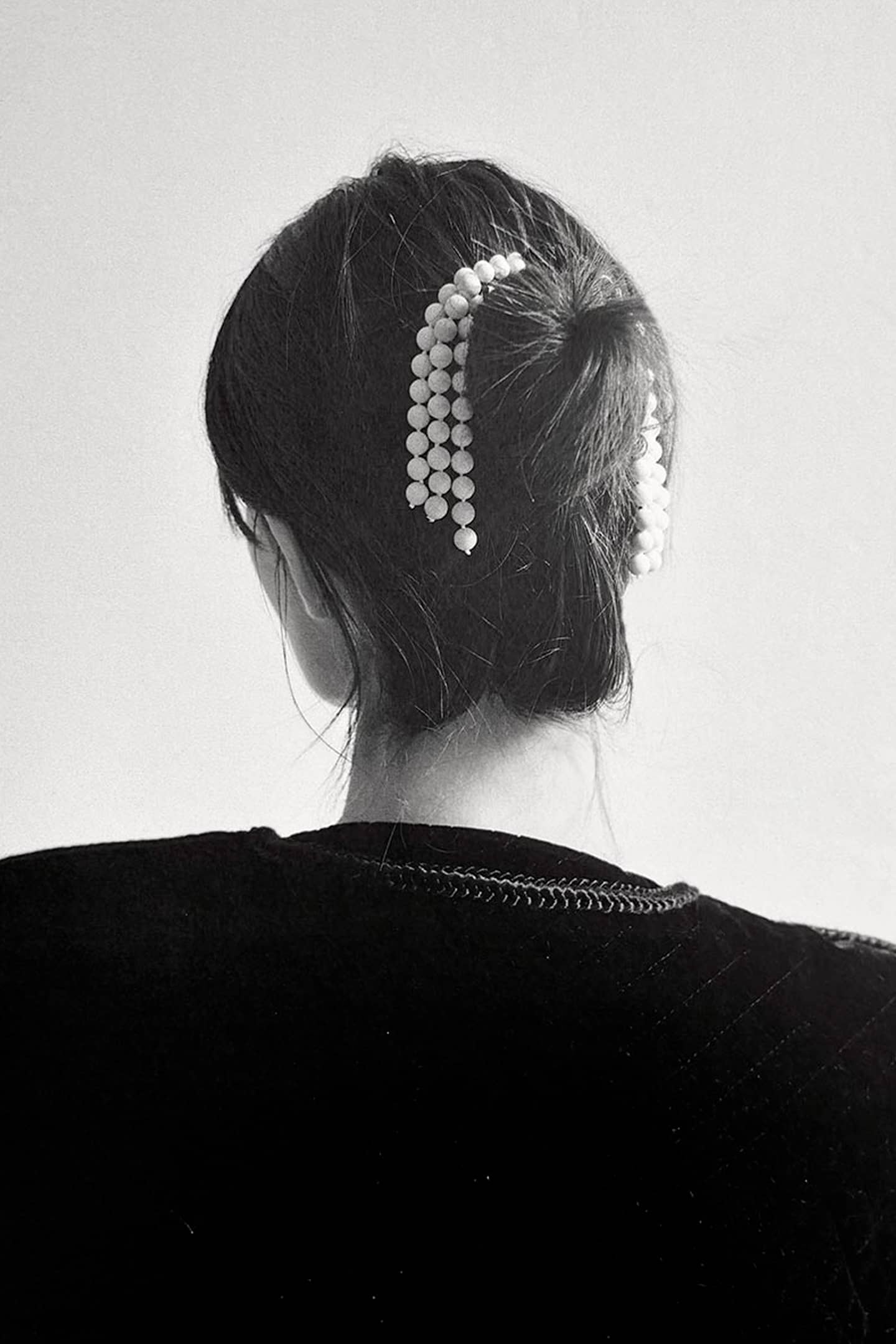 Full view of CANDE eco-friendly hair comb displaying recycled cellulose acetate and jade tassel design