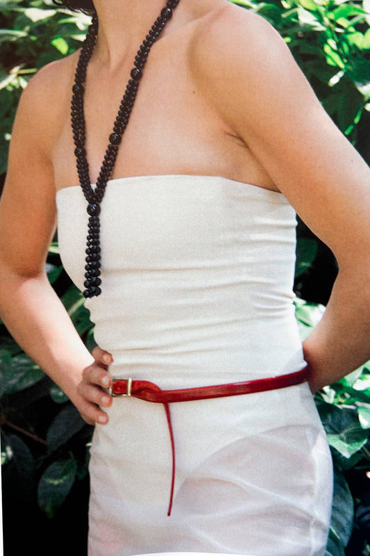 Close-up detail of FAROL necklace showing onyx gemstones natural black surface and premium artisan craftsmanship
